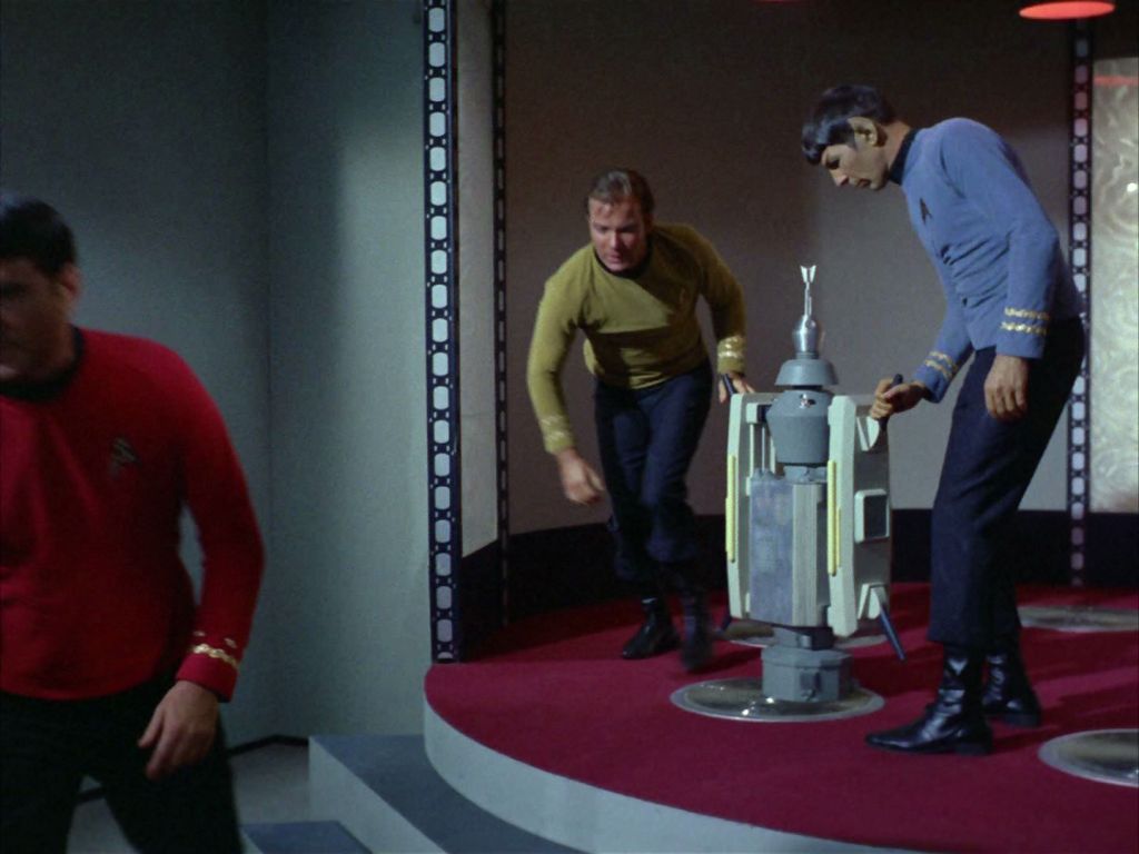 Kirk and Spock place Nomad which is being held with anti-grav devices on the transporter pad, from the Star Trek: The Original Series season 2, episode 8 "The Changeling".