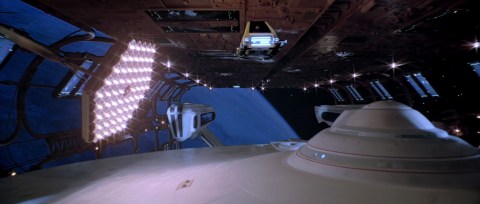 Workbee traveling overhead the U.S.S. Enterprise while she is in dry dock.