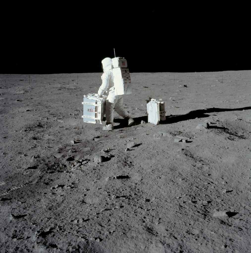Image of Buzz Aldrin carrying the Passive Seismic Experiment Package (PSEP) into position for deployment. Taken by Neil Armstrong on the moon, July 20th 1969. (Image courtesy: NASA)