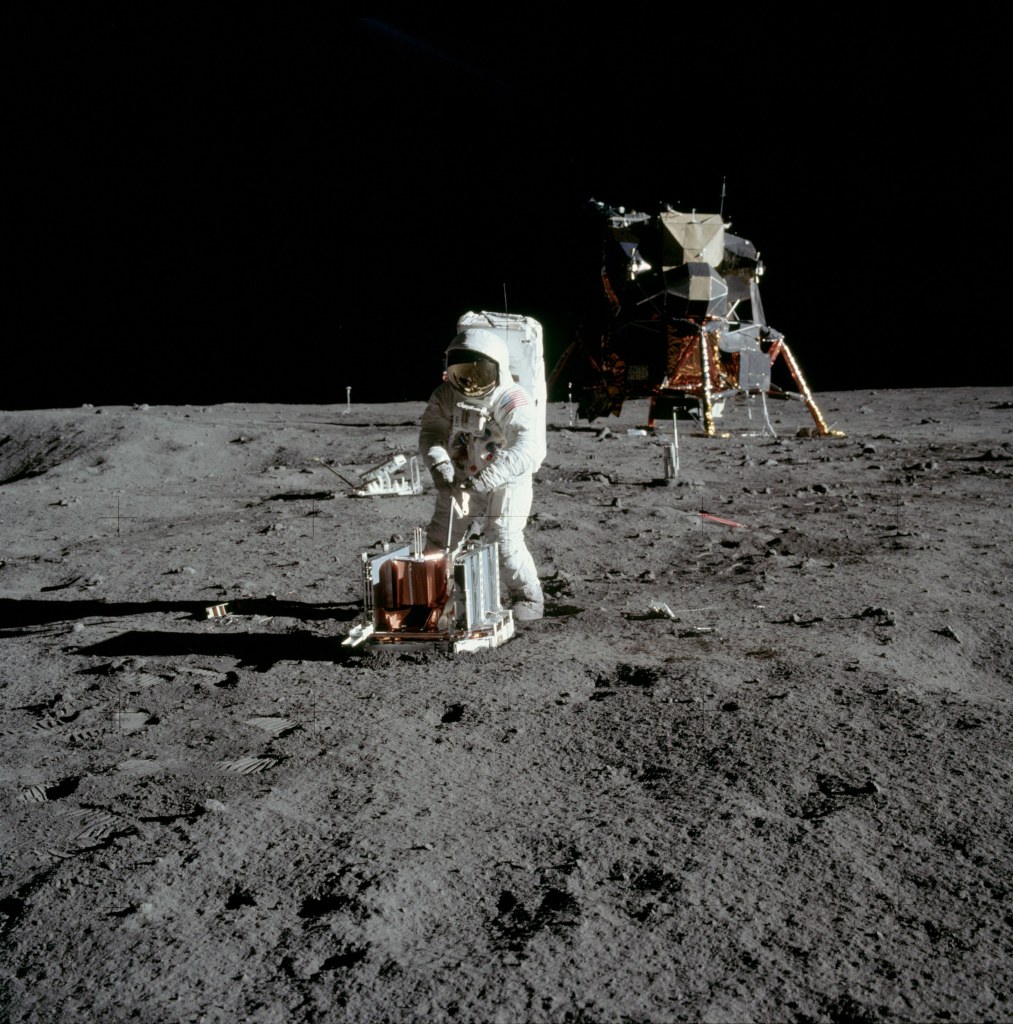 Image of Buzz Aldrin beginning to deploy the Passive Seismic Experiment Package (PSEP) with the Lunar Excursion Module (LEM) in the background, taken by Neil Armstrong on the moon, July 20th 1969. (Image courtesy: NASA)